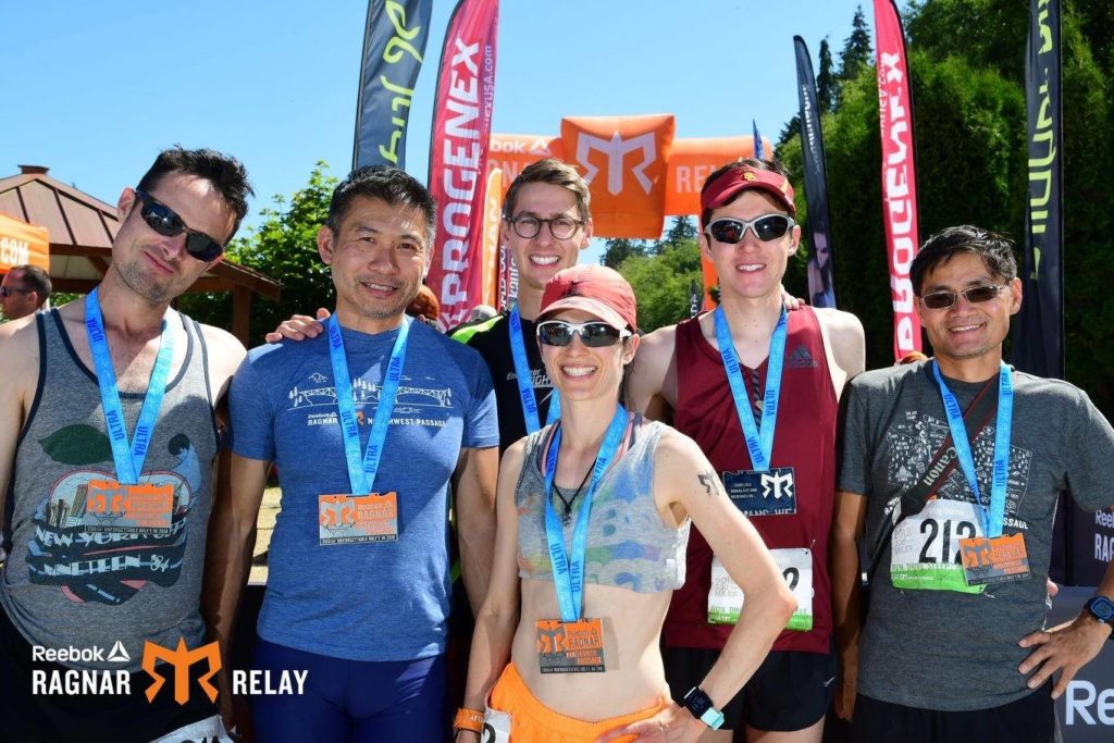 Ragnar finishers with medals, including a woman.